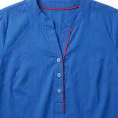 Close up of the notch neckline, three button placket and red contrast trim