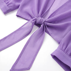 Close-up of the waist tie knot and sheer fabric