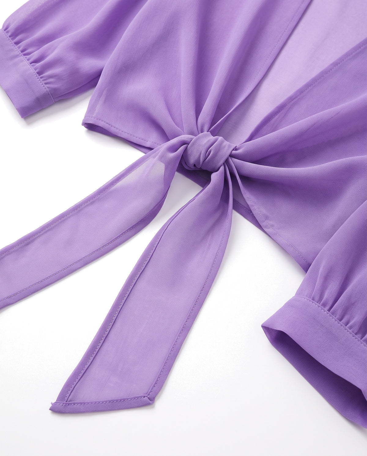 Close-up of the waist tie knot and sheer fabric