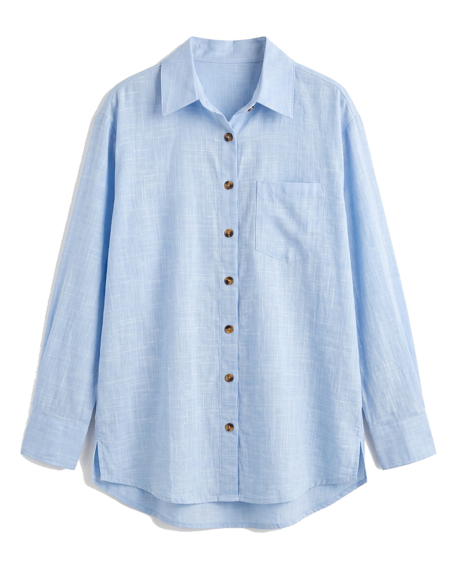 Blue oversized button-down shirt with chest pocket, front view on white