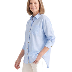 Woman wearing the blue oversized button-down shirt, three-quarter pose