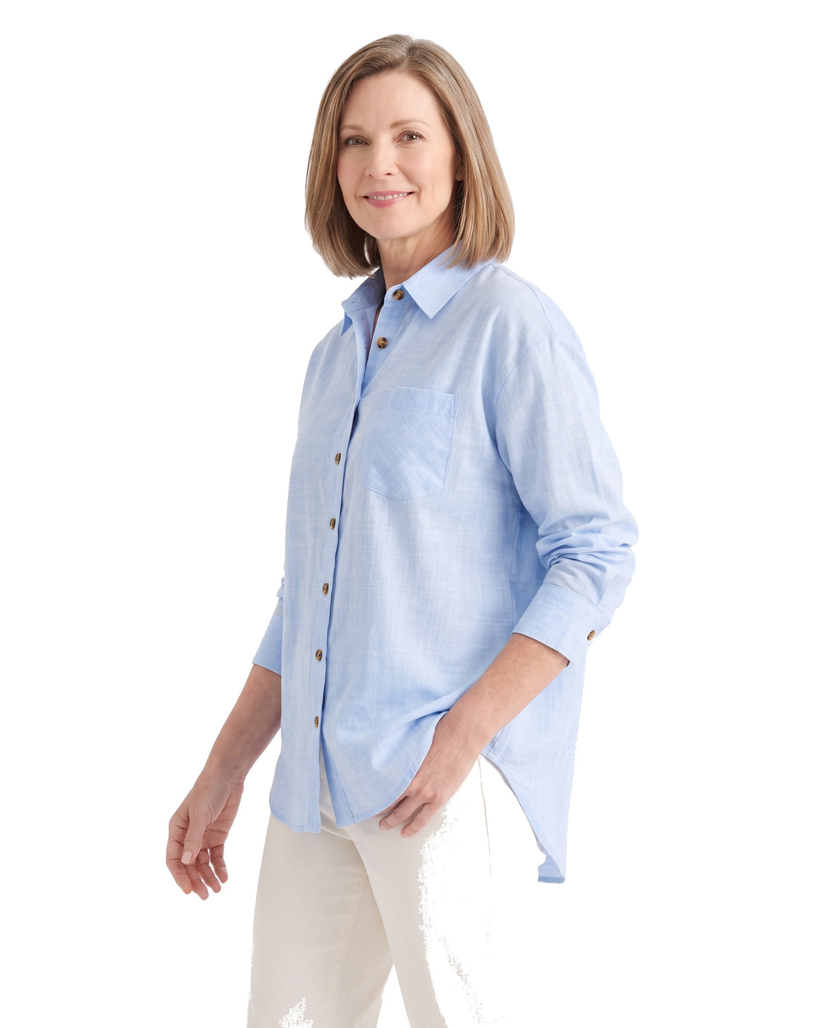 Woman wearing the blue oversized button-down shirt, three-quarter pose