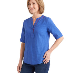 Woman wearing the blue tunic top, three quarter pose