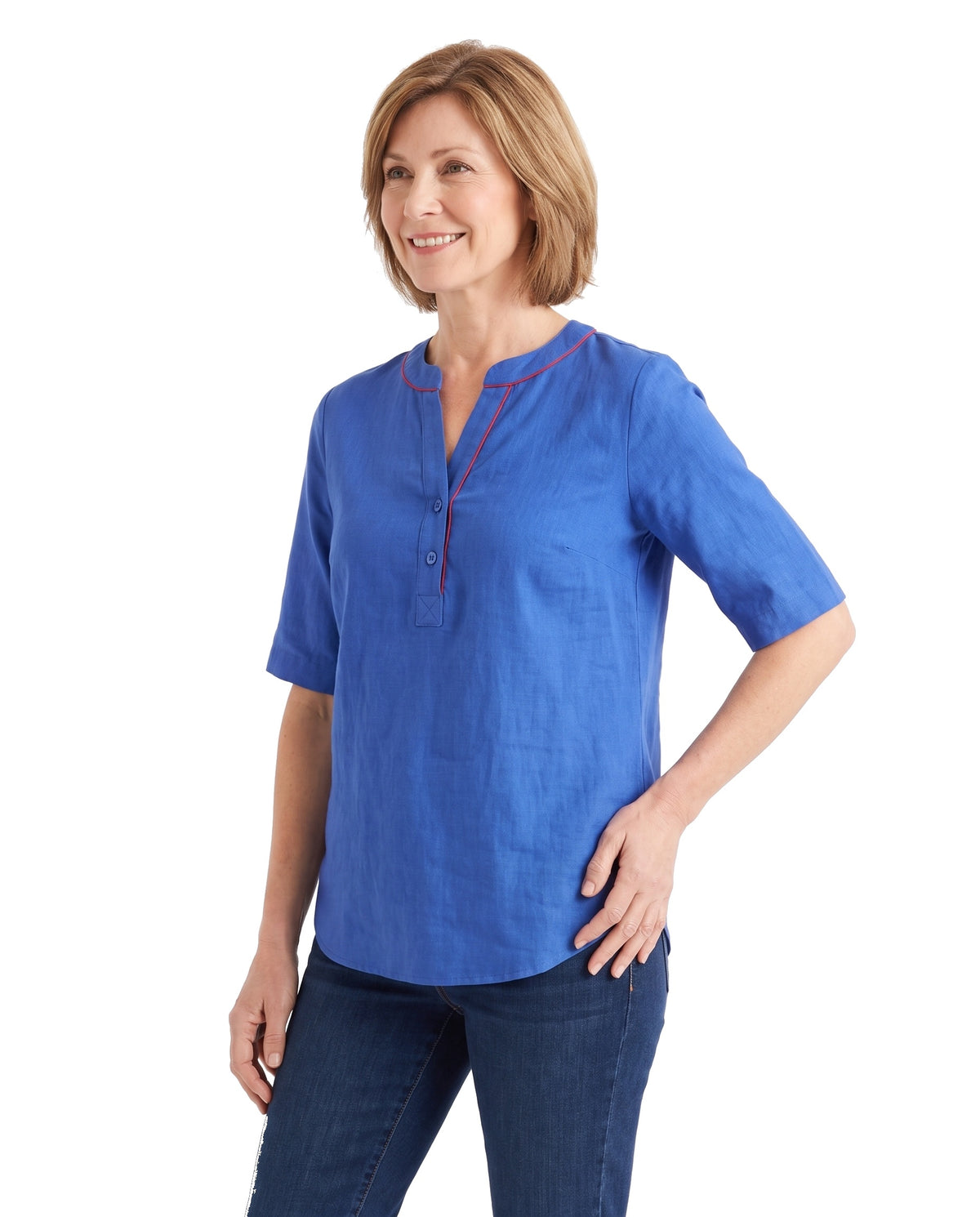 Woman wearing the blue tunic top, three quarter pose