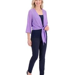 Model wearing the sheer tie-front shrug, three-quarter walking pose