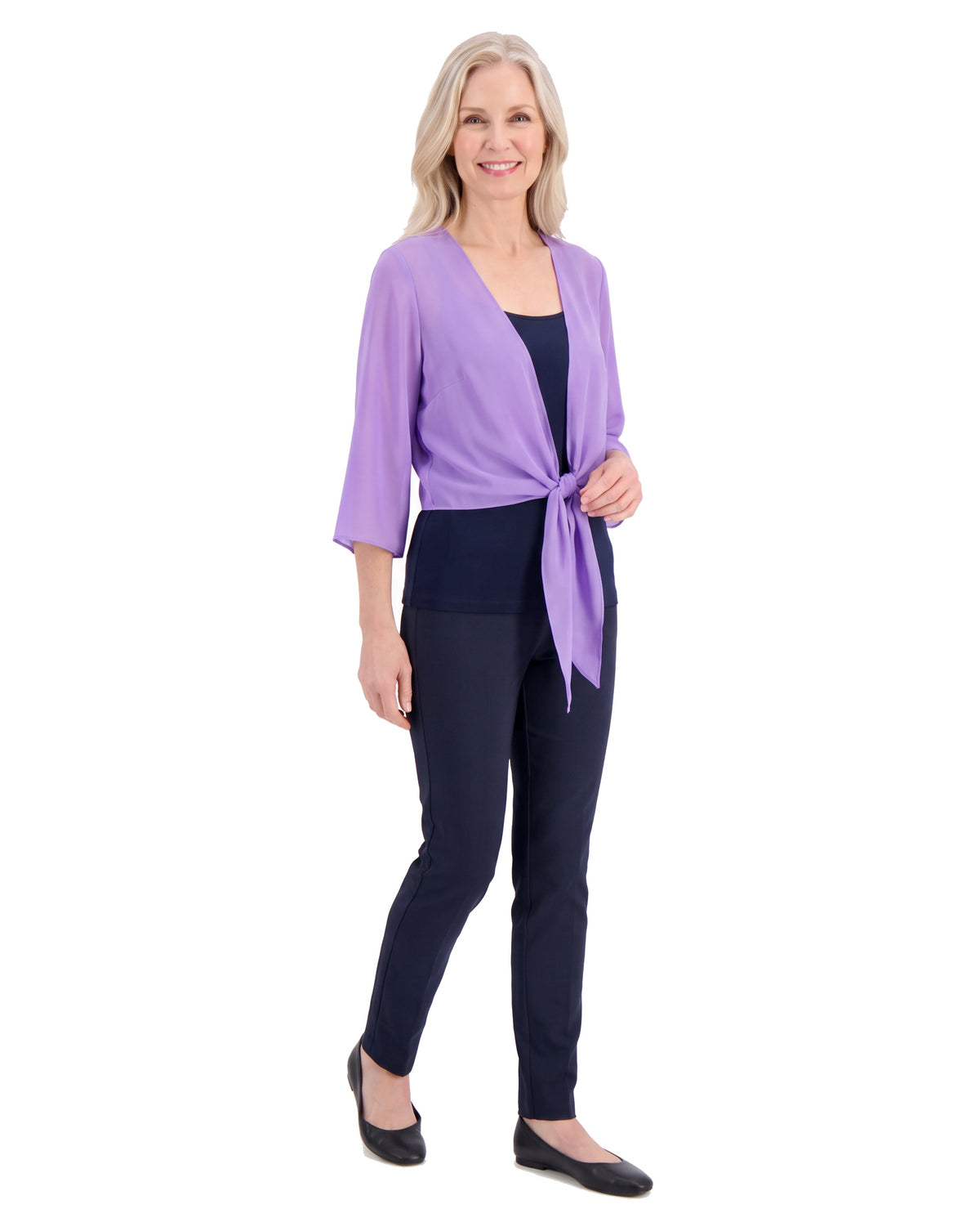 Model wearing the sheer tie-front shrug, three-quarter walking pose