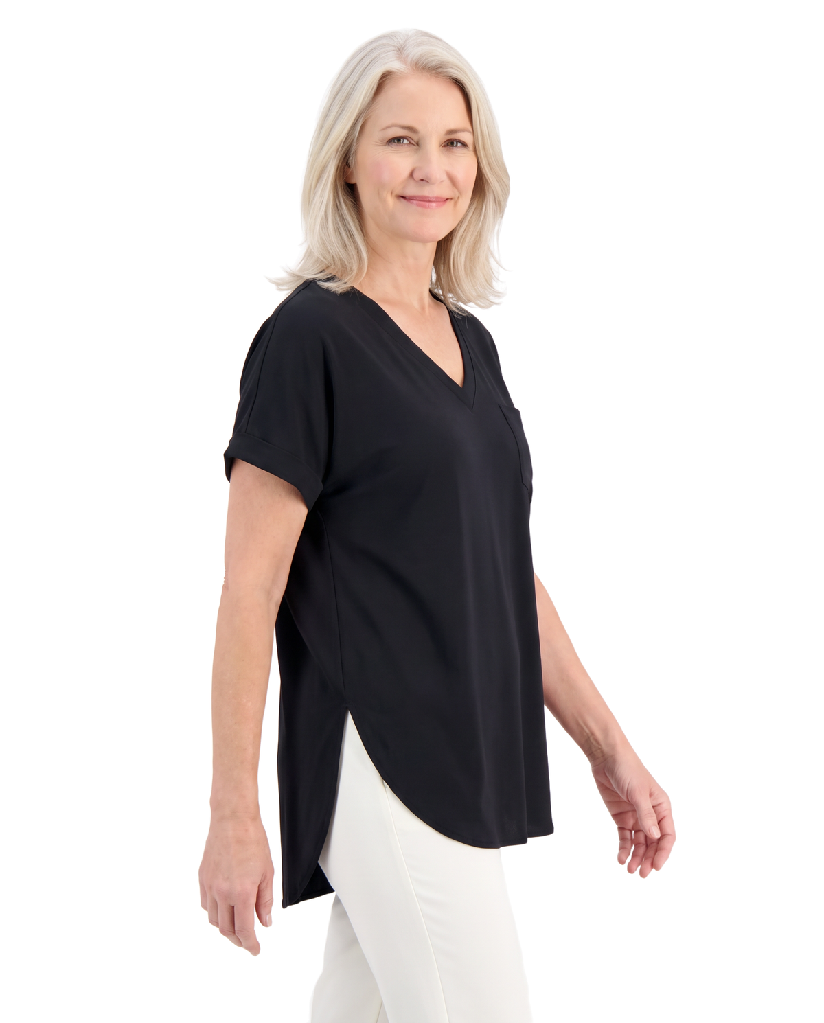 Model wearing the black loose V neck top, three quarter view showing the side slit