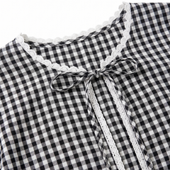 Close-up of the lace-trimmed neckline and tie bow