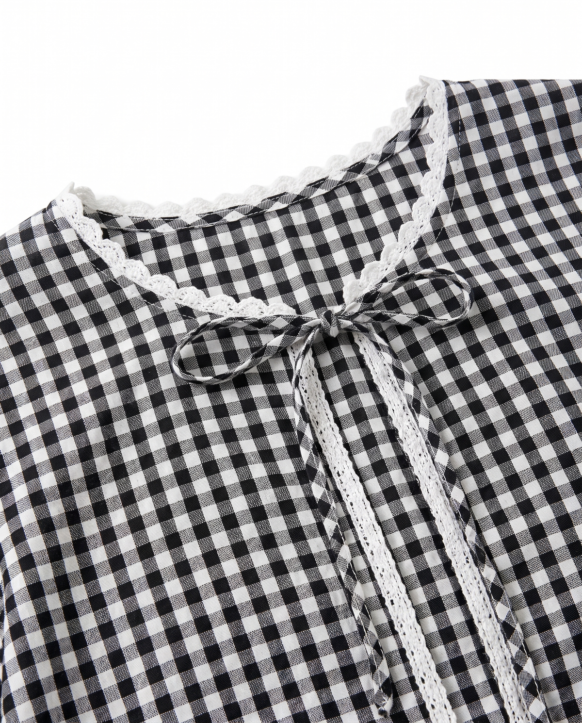 Close-up of the lace-trimmed neckline and tie bow